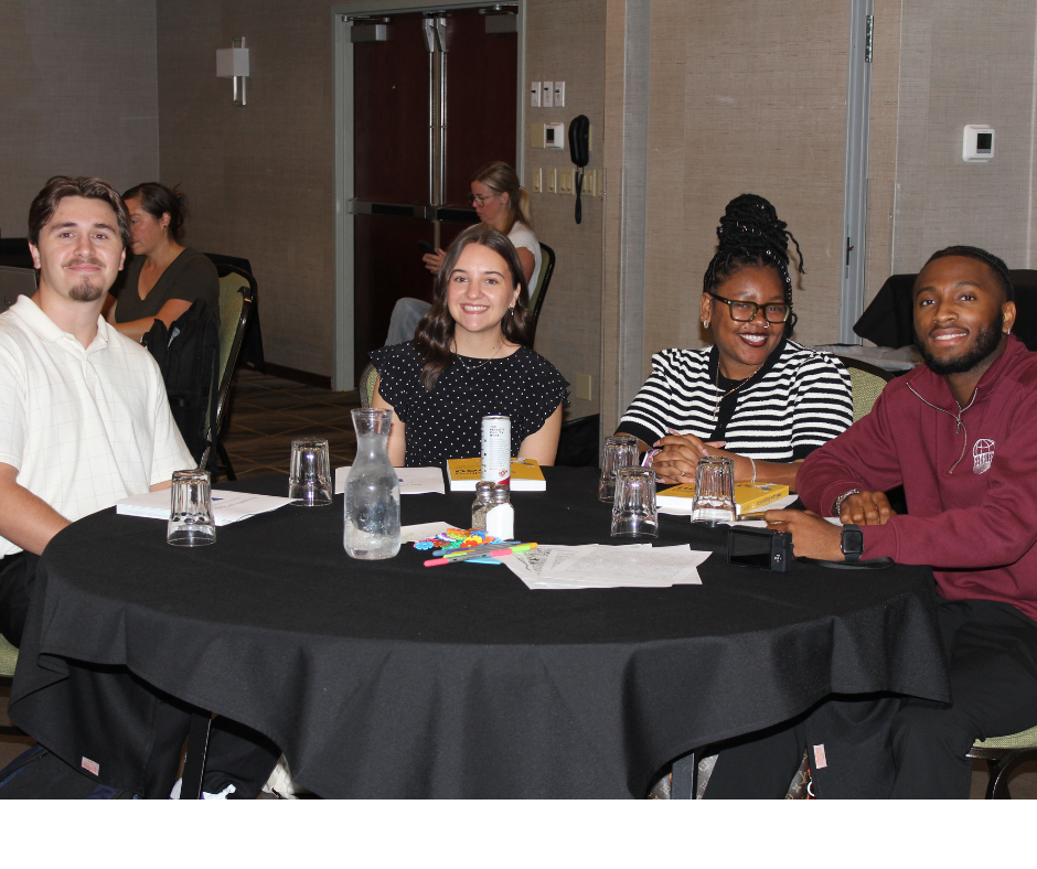 4 student interns posing for a photo at the event.