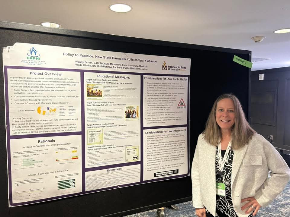 woman in front of an academic poster.